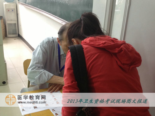 2013年衛(wèi)生專業(yè)技術(shù)考試考場(chǎng)-考官認(rèn)真核查考生信息